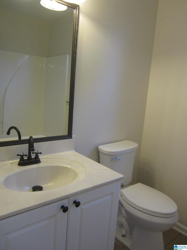 bathroom featuring vanity, toilet, and tile patterned floors