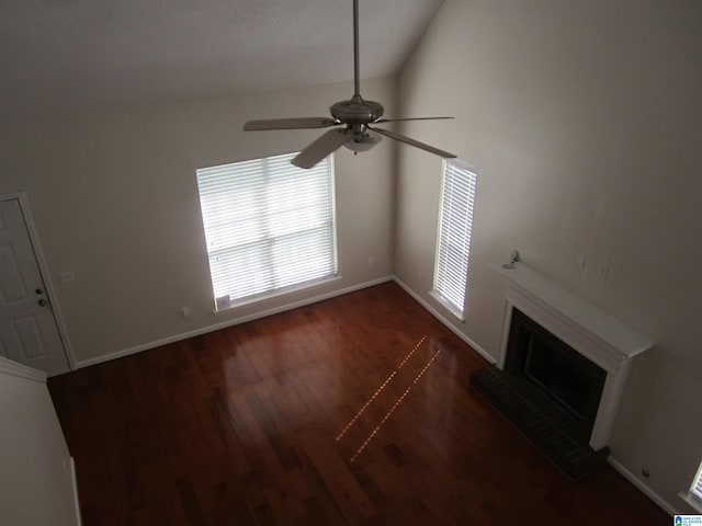 unfurnished living room with vaulted ceiling, ceiling fan, and dark wood-type flooring