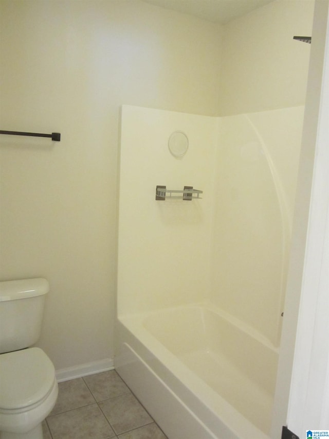 bathroom featuring tub / shower combination, toilet, and tile patterned floors