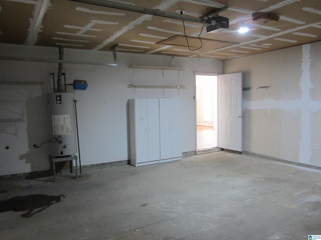 garage featuring gas water heater and a garage door opener