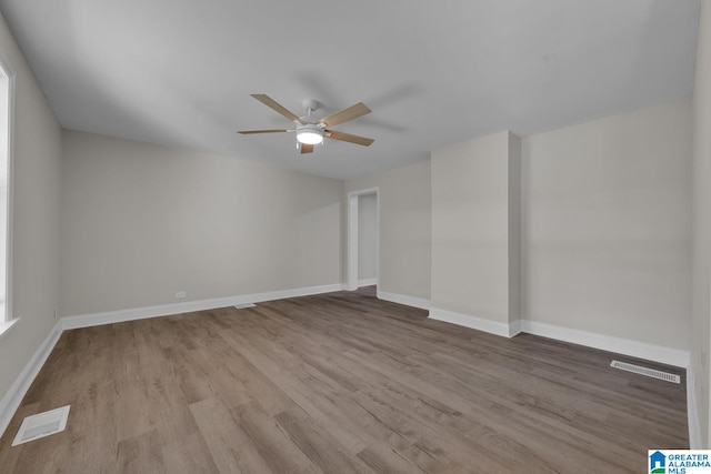 empty room featuring ceiling fan and light hardwood / wood-style flooring