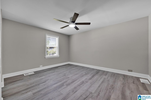 spare room featuring light hardwood / wood-style floors and ceiling fan