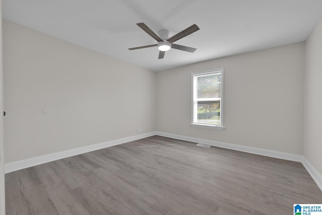 unfurnished room featuring light wood-type flooring and ceiling fan