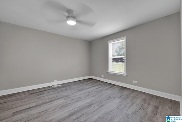 unfurnished room with ceiling fan and light hardwood / wood-style flooring