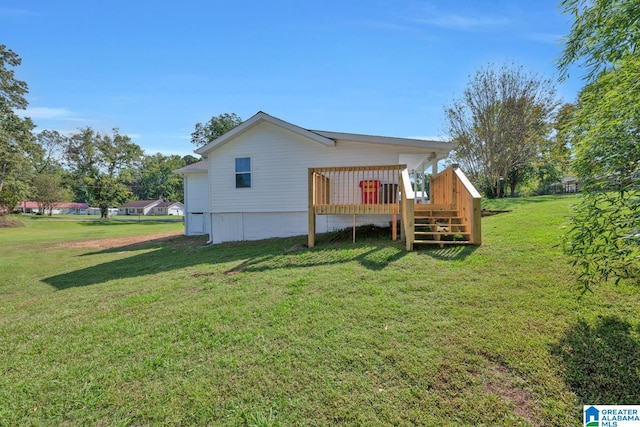 rear view of property with a yard and a deck