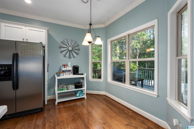 interior space featuring crown molding, dark wood-type flooring, and plenty of natural light