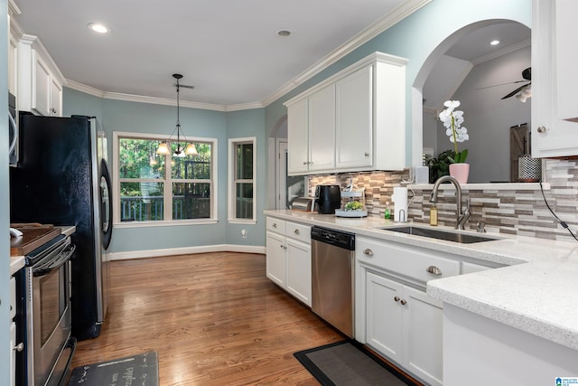 kitchen featuring appliances with stainless steel finishes, light stone countertops, sink, and white cabinets