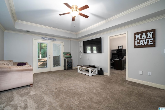 sitting room with french doors, carpet floors, a raised ceiling, and ornamental molding