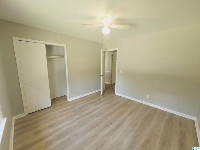 unfurnished bedroom with light hardwood / wood-style flooring, a closet, and ceiling fan