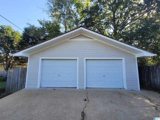 detached garage featuring fence