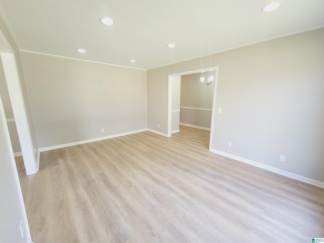 empty room featuring recessed lighting, light wood-style floors, baseboards, and crown molding