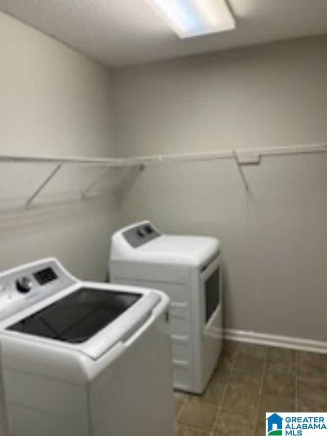 clothes washing area featuring washer and clothes dryer