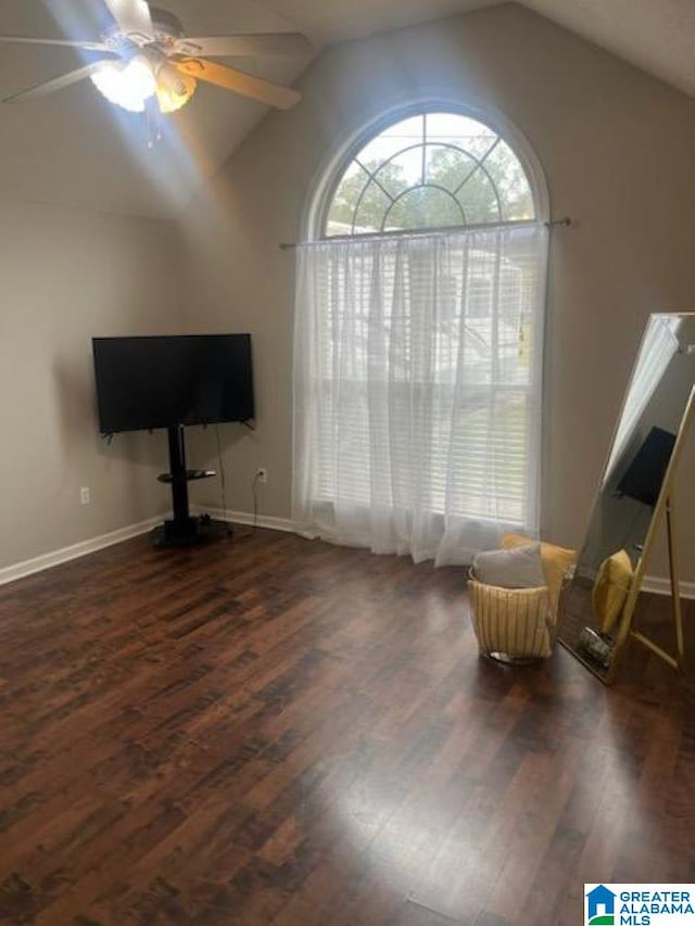 unfurnished room with ceiling fan, dark hardwood / wood-style flooring, and vaulted ceiling