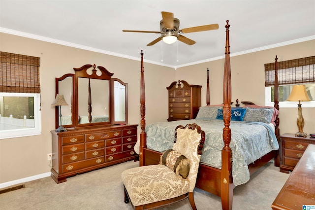 carpeted bedroom with ceiling fan and ornamental molding