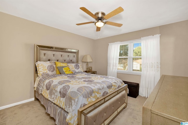 bedroom with ceiling fan and light carpet