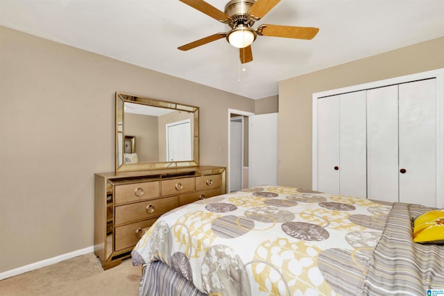 carpeted bedroom featuring ceiling fan and a closet