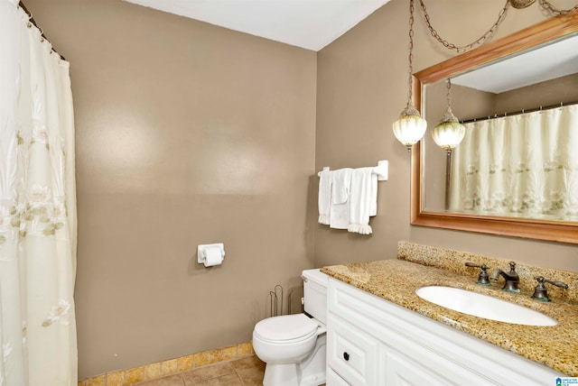 bathroom with vanity, toilet, and tile patterned floors