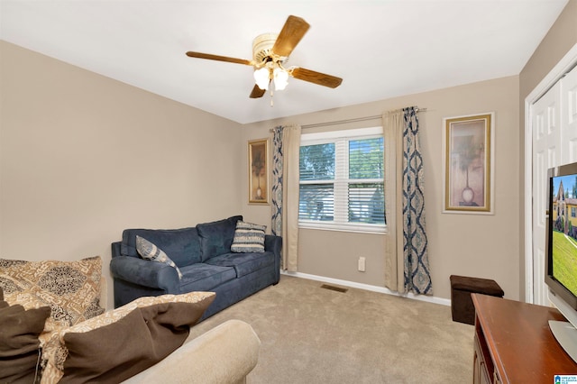 living room with ceiling fan and light colored carpet