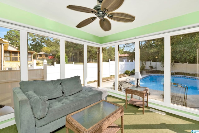 sunroom featuring ceiling fan and a healthy amount of sunlight