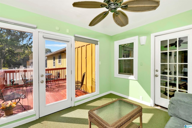 sunroom featuring ceiling fan