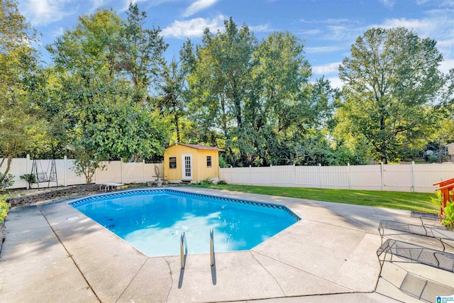 view of pool featuring a shed and a patio area