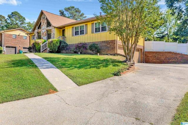 view of front of home with a garage and a front yard