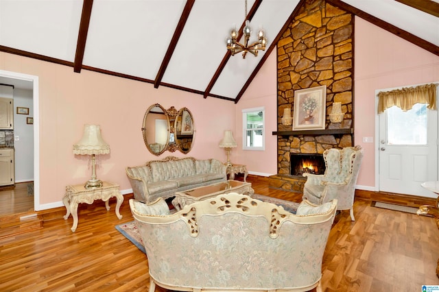 living room featuring beamed ceiling, light hardwood / wood-style floors, and a healthy amount of sunlight