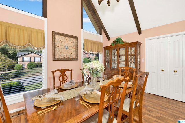 dining space with beam ceiling, dark wood-type flooring, and high vaulted ceiling