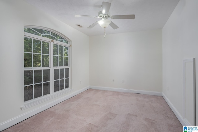 unfurnished room featuring ceiling fan and light colored carpet