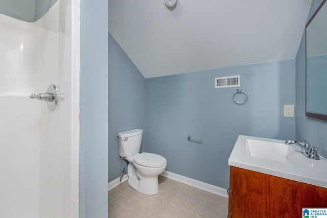 bathroom with vanity, lofted ceiling, toilet, and tile patterned floors