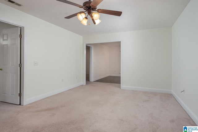 carpeted empty room featuring ceiling fan