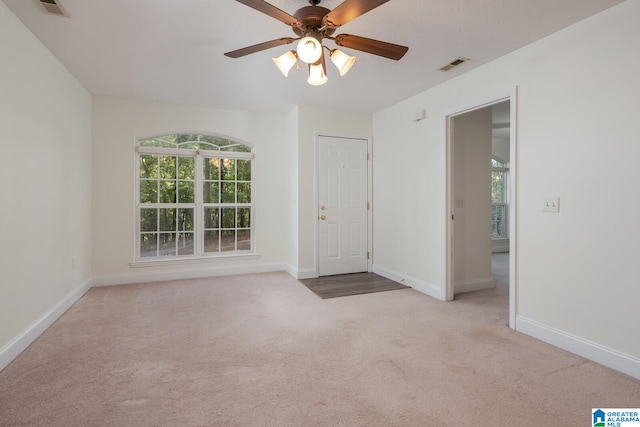 carpeted empty room featuring ceiling fan