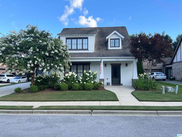 view of front of home with covered porch and a front yard