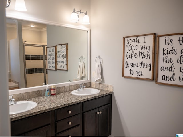 bathroom featuring ornamental molding, an enclosed shower, and vanity