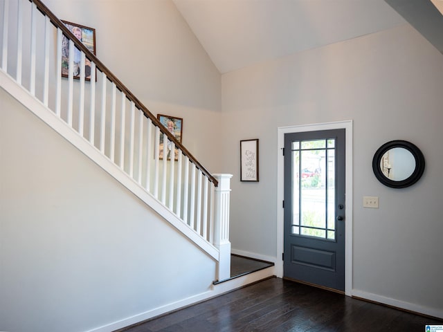 foyer with high vaulted ceiling and dark hardwood / wood-style flooring