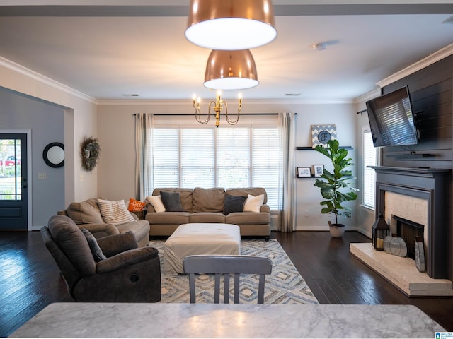 living room with dark wood-type flooring, ornamental molding, and a stone fireplace