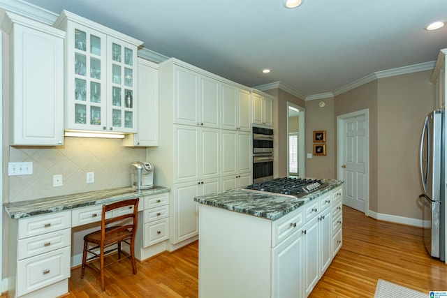 kitchen with light wood-type flooring, white cabinetry, and stainless steel appliances