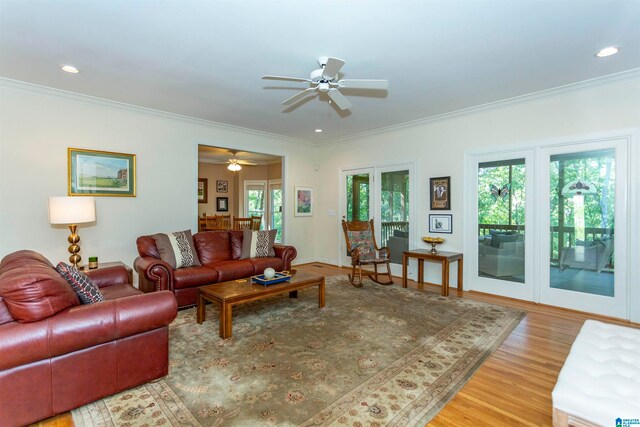 living room featuring french doors, crown molding, hardwood / wood-style floors, and a wealth of natural light