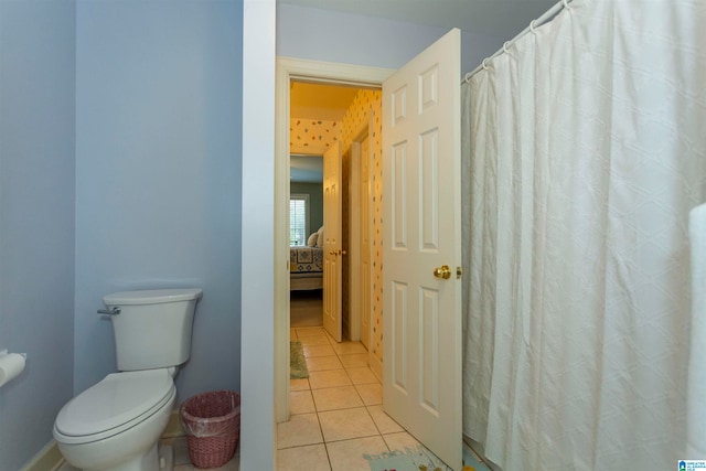 bathroom with toilet and tile patterned floors