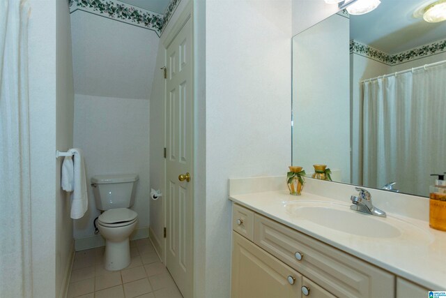 bathroom featuring vanity, tile patterned flooring, and toilet