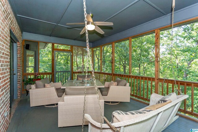 sunroom / solarium featuring ceiling fan and a wealth of natural light