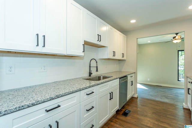 kitchen featuring light stone counters, white cabinets, sink, dark wood-type flooring, and dishwasher