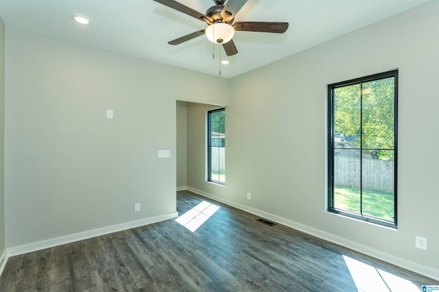 empty room with ceiling fan and dark hardwood / wood-style floors