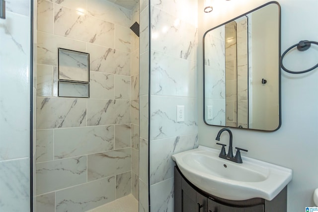 bathroom featuring vanity and a tile shower