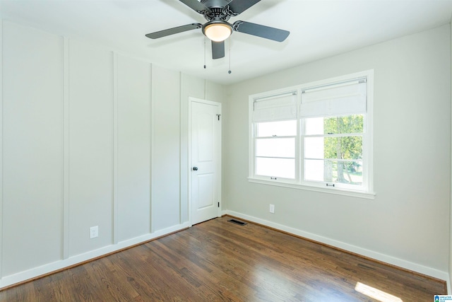 unfurnished bedroom with ceiling fan and dark hardwood / wood-style flooring