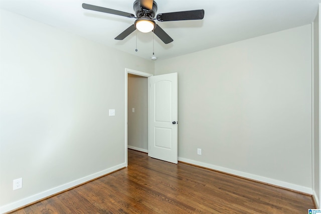 spare room with dark hardwood / wood-style flooring and ceiling fan