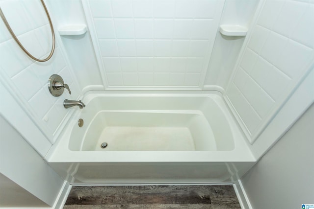 bathroom featuring wood-type flooring and shower / washtub combination