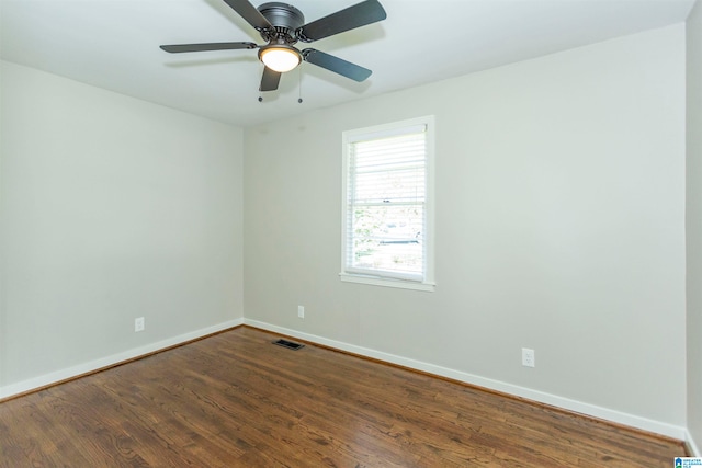 unfurnished room with ceiling fan and dark wood-type flooring