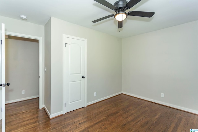 unfurnished bedroom featuring a closet, dark hardwood / wood-style flooring, and ceiling fan