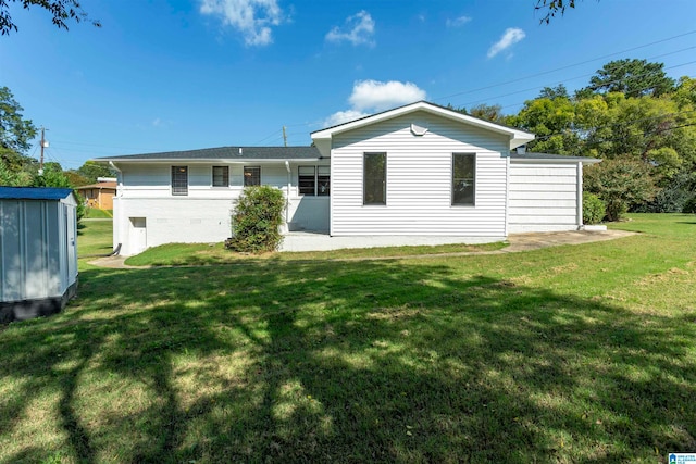 back of house with a yard and a storage unit